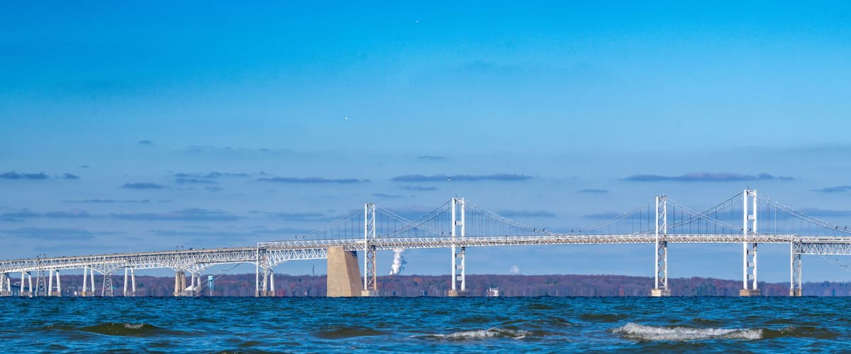 The Chesapeake Bay Bridge under a brilliant blue sky on a crisp autumn day.