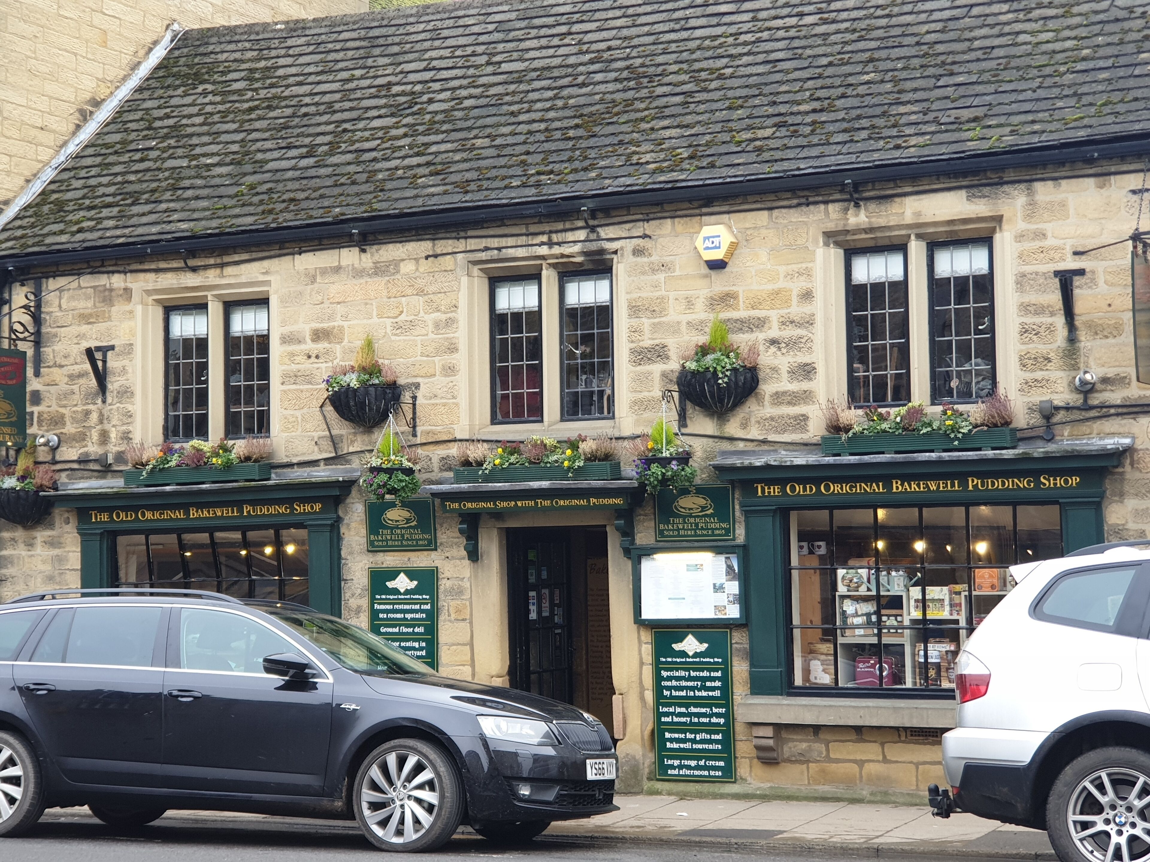 A historic building with a sign for 'The Old Original Bakewell Pudding Shop'.