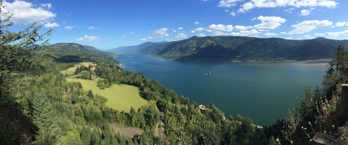 A lake surrounded by mountains and dense forests.