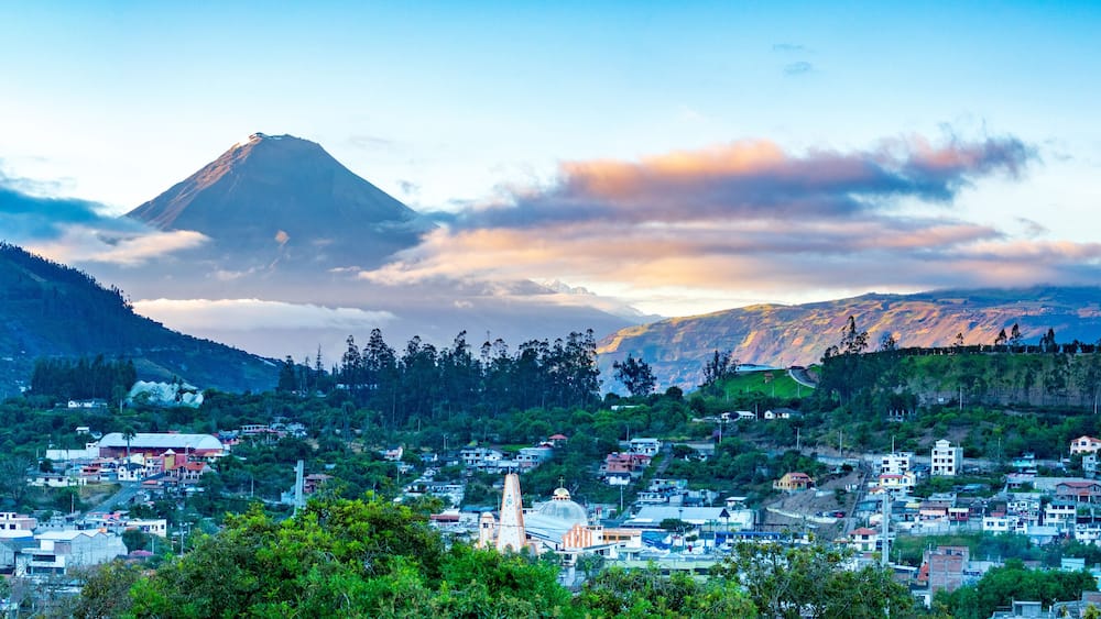 Panorama of town and volcano during sunrise in Andes of Ecuacor