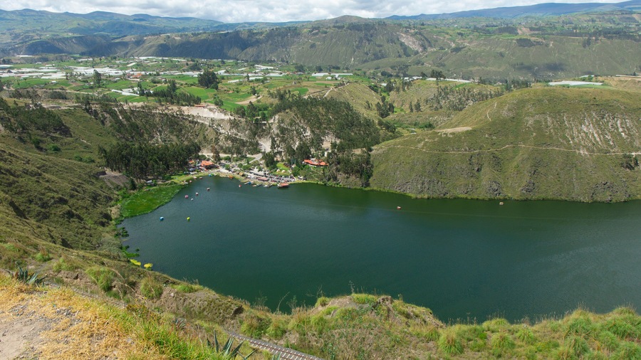Panoramic view boats sailing in the Yambo lagoon on a sunny day near the city of Salcedo in the province of Cotopaxi - Ecuador