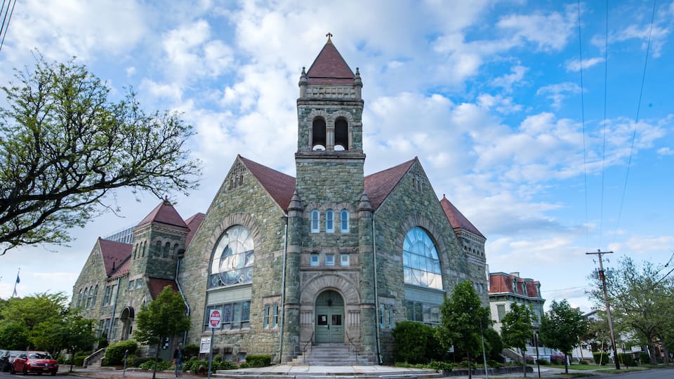 A large stone church with a prominent tower and arched windows.