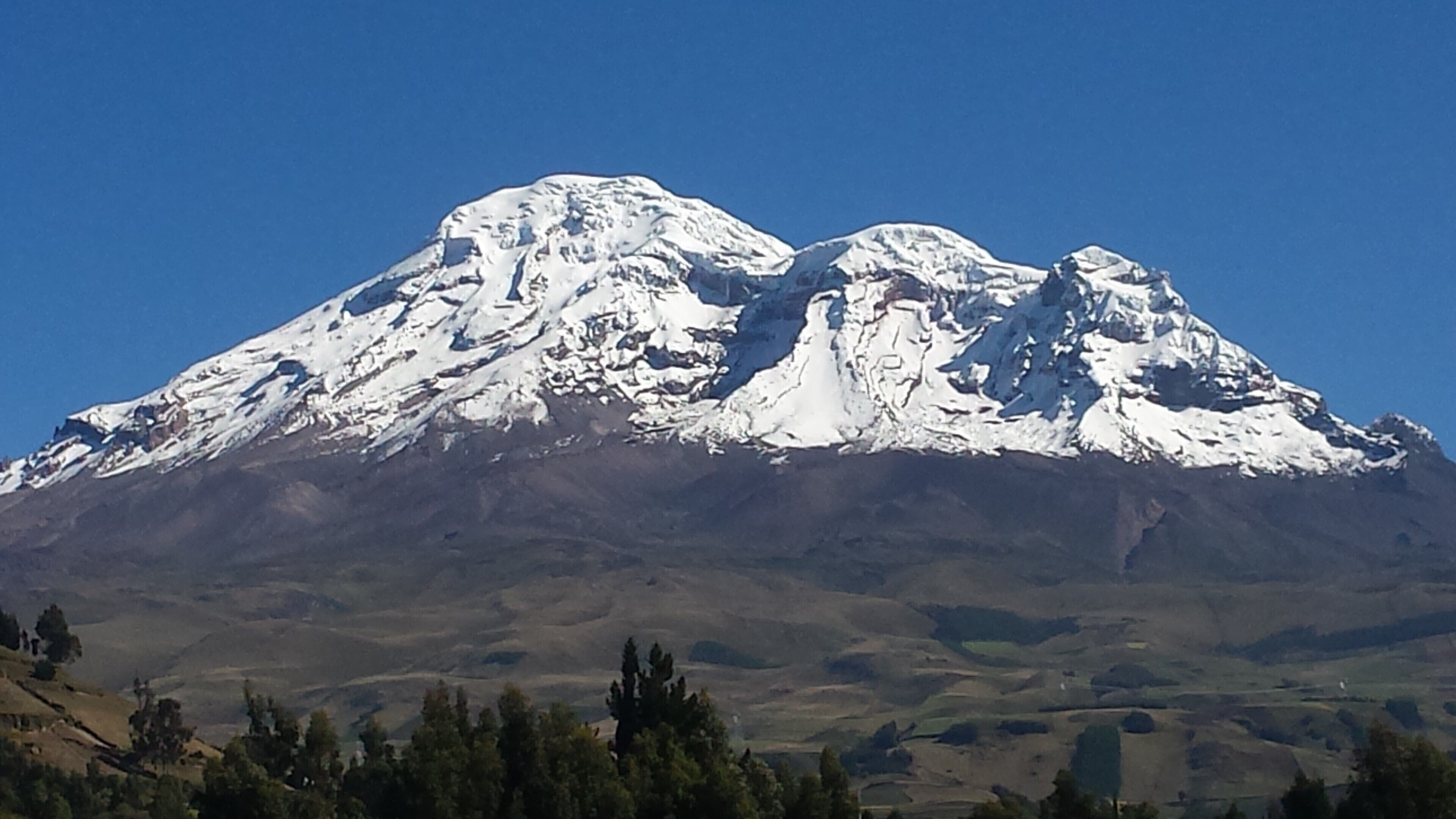A snow-capped mountain with a clear sky.