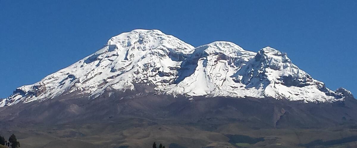 A snow-capped mountain with a clear sky.