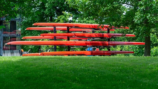 Stack of red kayaks arranged on an outdoor rack on the Charles riverbank, Watertown, Massachusetts, USA