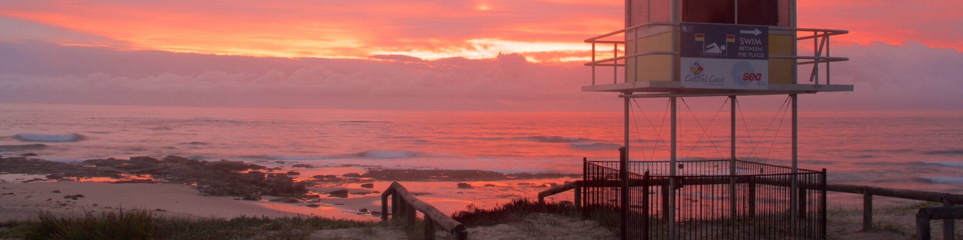 The Entrance featuring a beach and a sunset