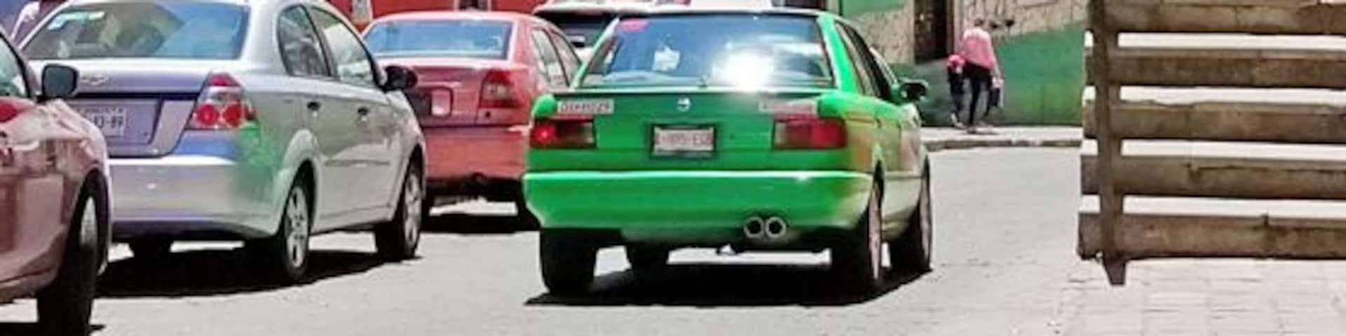 Green taxis, purple trees, golden churches, rainbow houses - the view from the side steps of the Alhondiga, down to the Mercado Hidalgo.
