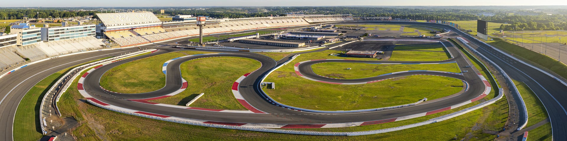 Concord, United States - 28 July 2025: Aerial view of Charlotte Motor Speedway, where the vibrant green infield contrasts sharply with the gray asphalt tracks.