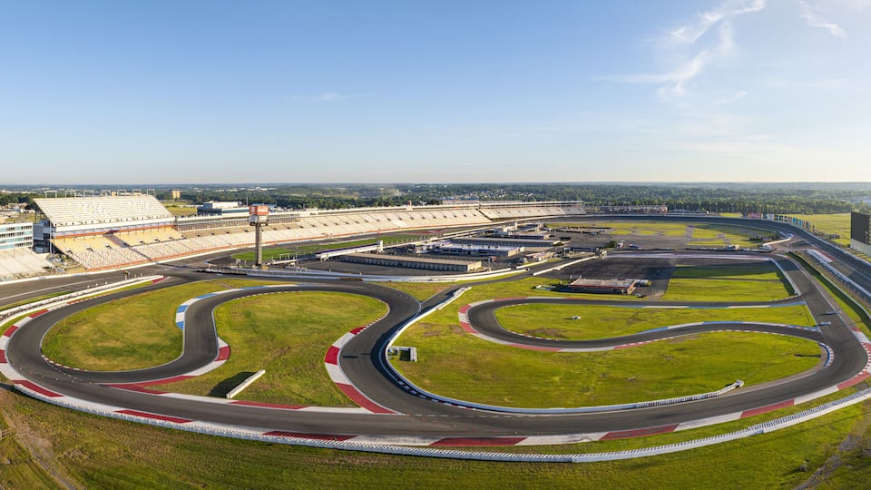A racetrack with multiple curves and a grandstand.