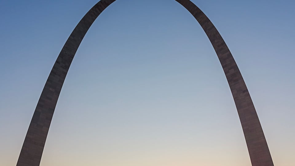 The Gateway Arch with a sunset in the background.