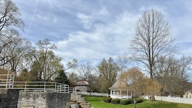 Stone canal lock and waterfall beside gazebo in peaceful town park