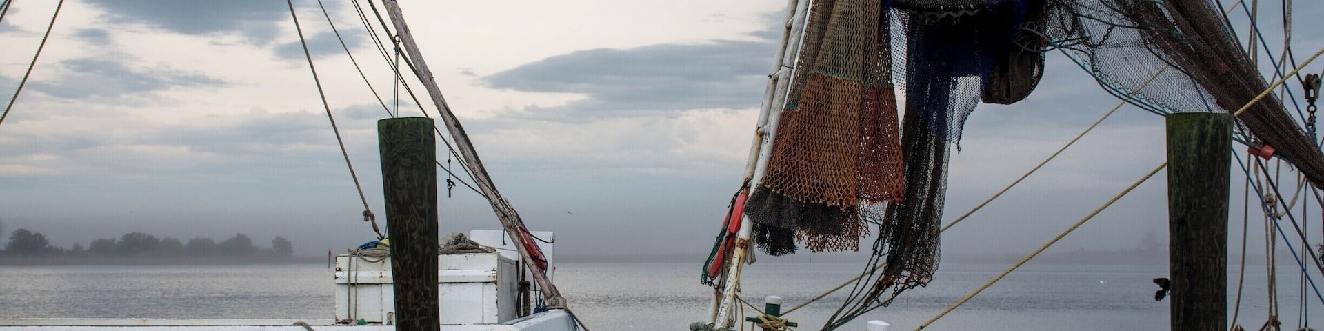Oyster/fishing boats at Apalachicola, Florida. Apalachicola is a small city along what is sometimes referred to as the Forgotten Coast on the Gulf coast of the Florida panhandle. Oyster and shrimp fishing continue to be important elements of the economy, and the town has a slower pace than the big resort areas elsewhere in the state.