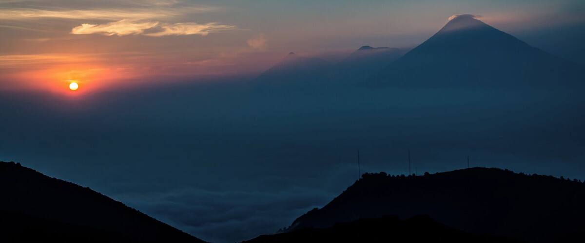 Sunset view from Pacaya volcano towards three other volcanos down the road. The trip up Pacaya is fairly easy and can be done in an afternoon, though not to the summit itself fue to security restriction (volcano activity). Your starting point is Antigua de Guatemala.