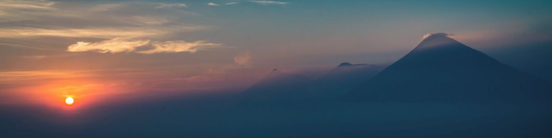 Sunset view from Pacaya volcano towards three other volcanos down the road. The trip up Pacaya is fairly easy and can be done in an afternoon, though not to the summit itself fue to security restriction (volcano activity). Your starting point is Antigua de Guatemala.