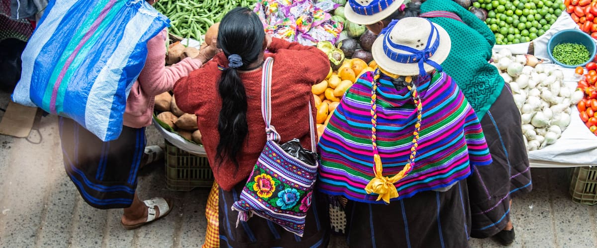 A market with vendors selling vegetables and fruits.