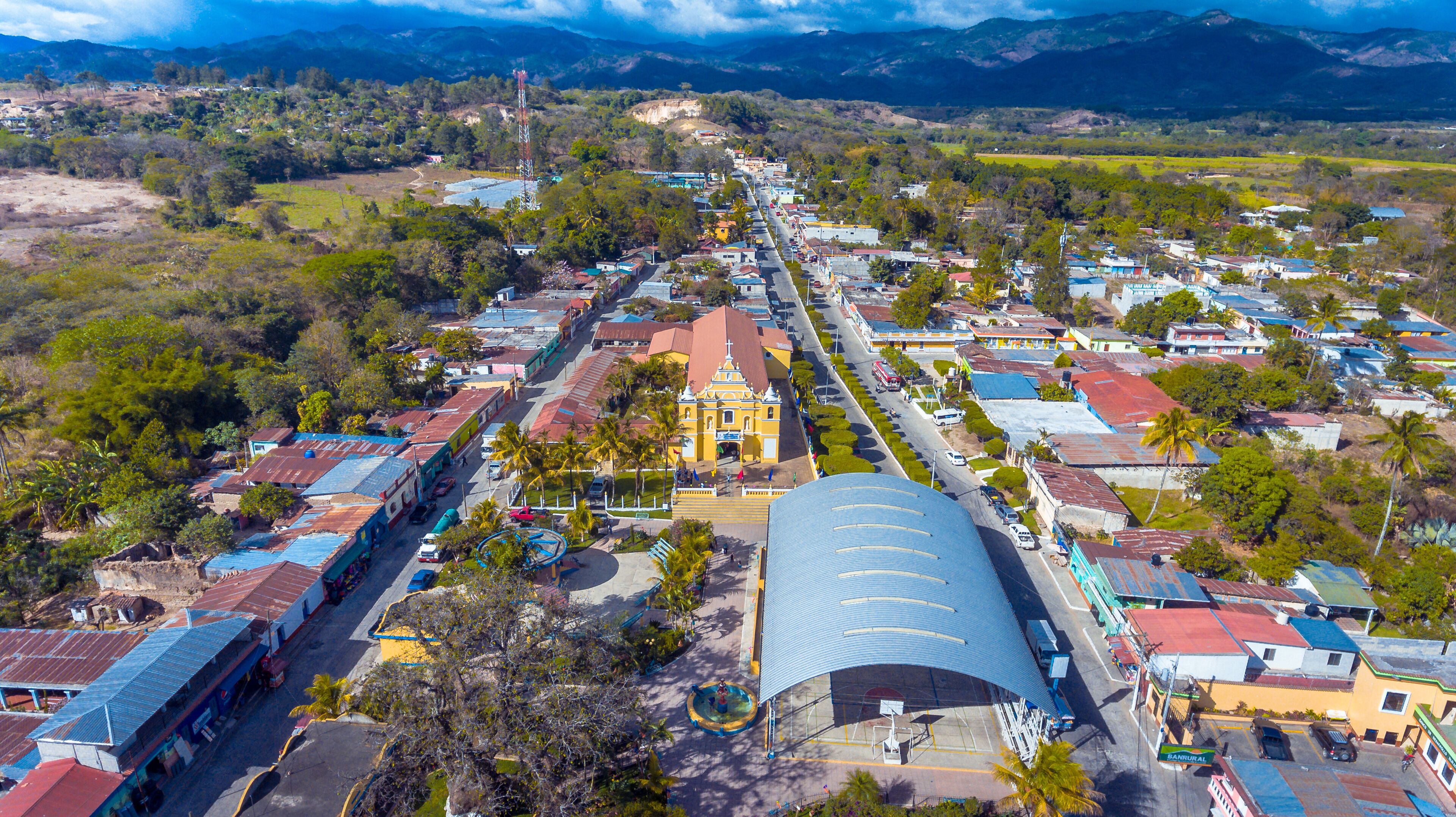 A town with a prominent church, a sports stadium, and a mix of residential and commercial buildings.