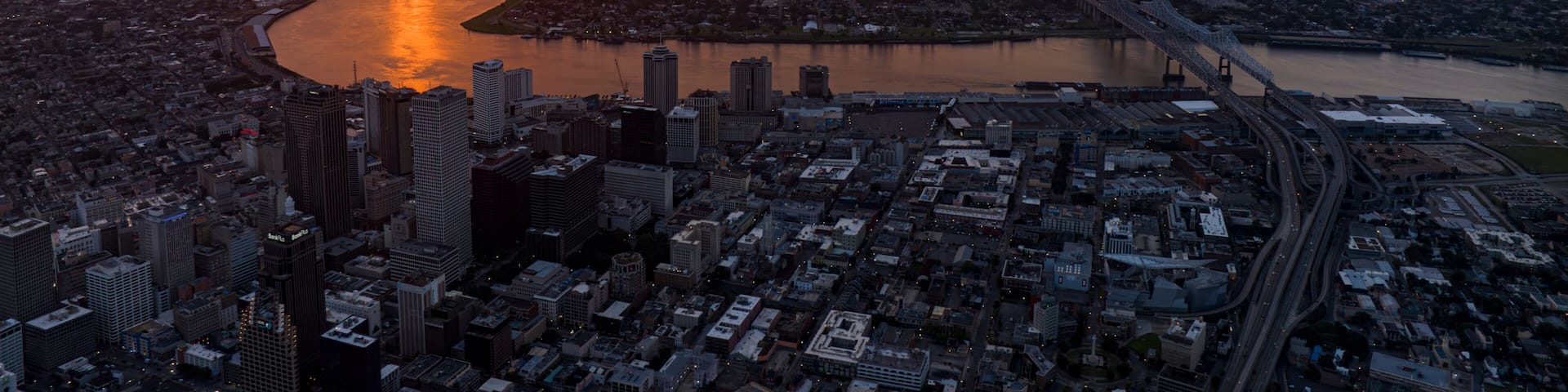 JULY 14, 2023 - NEW ORLEANS - LA - USA - aerial view of New Orleans skyline with Mississippi River in backgound at sunrise
