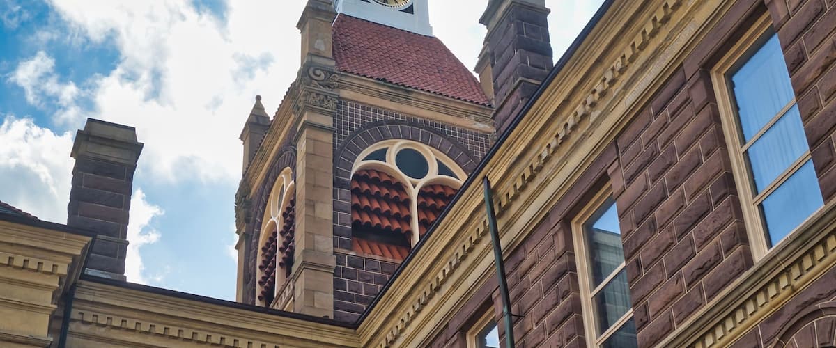 A historic building with a clock tower and arched windows.