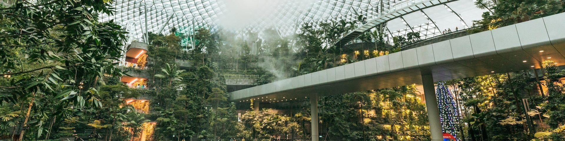 Jewel Changi Airport featuring interior views, a fountain and a garden