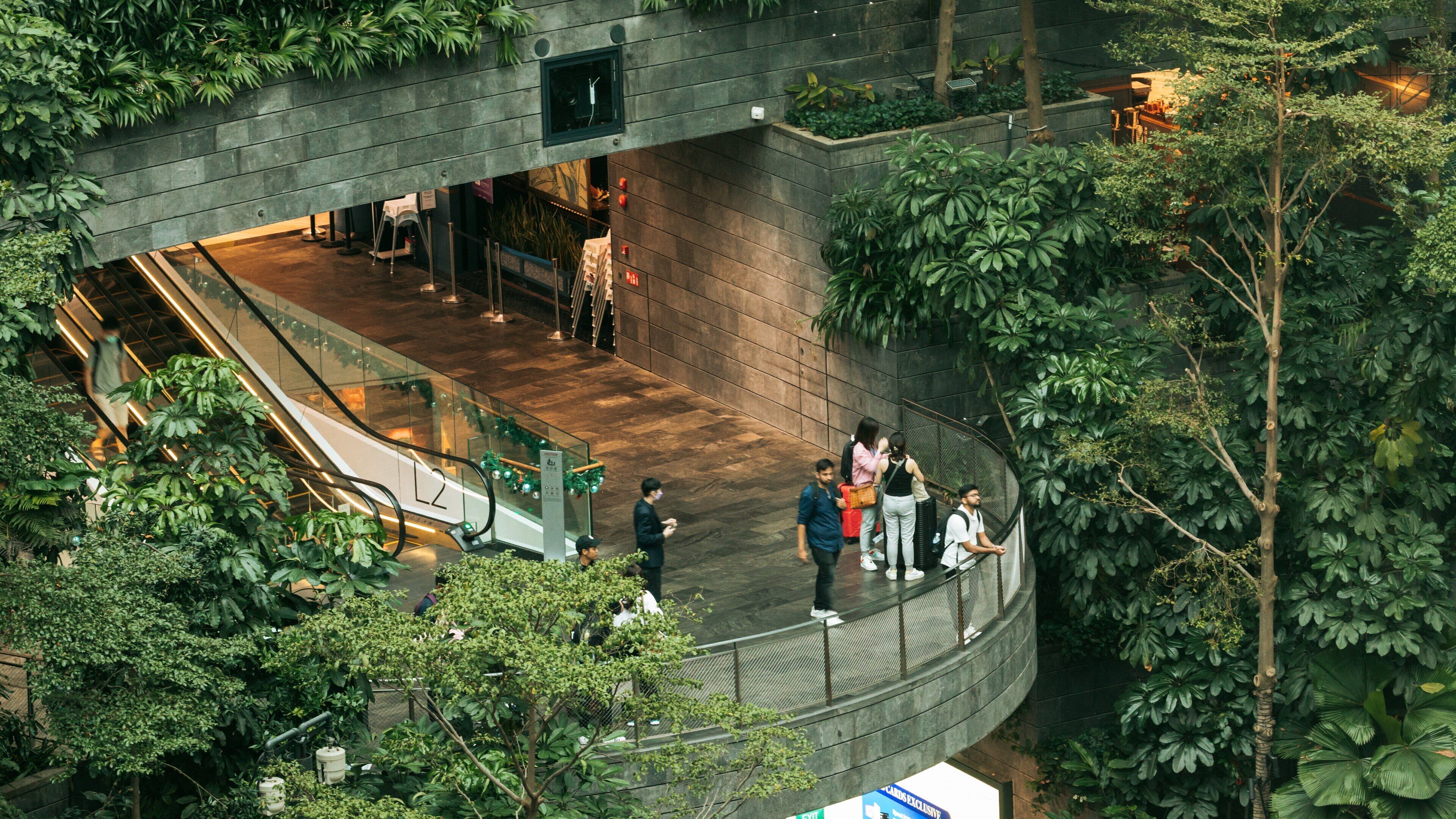 Jewel Changi Airport featuring interior views and a park as well as a small group of people
