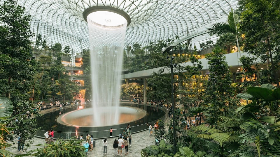Jewel Changi Airport featuring a garden, a fountain and interior views