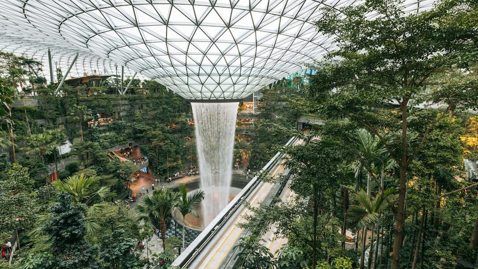 Jewel Changi Airport featuring a fountain, a garden and interior views
