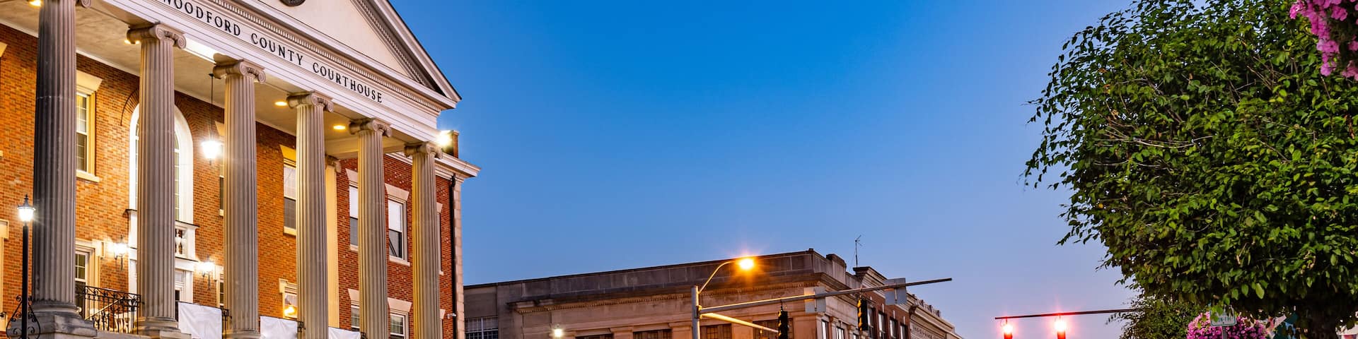 Taillights trails of early morning traffic on Main Street of a small mid west city of Versailles, KY in front of Woodford county courthouse