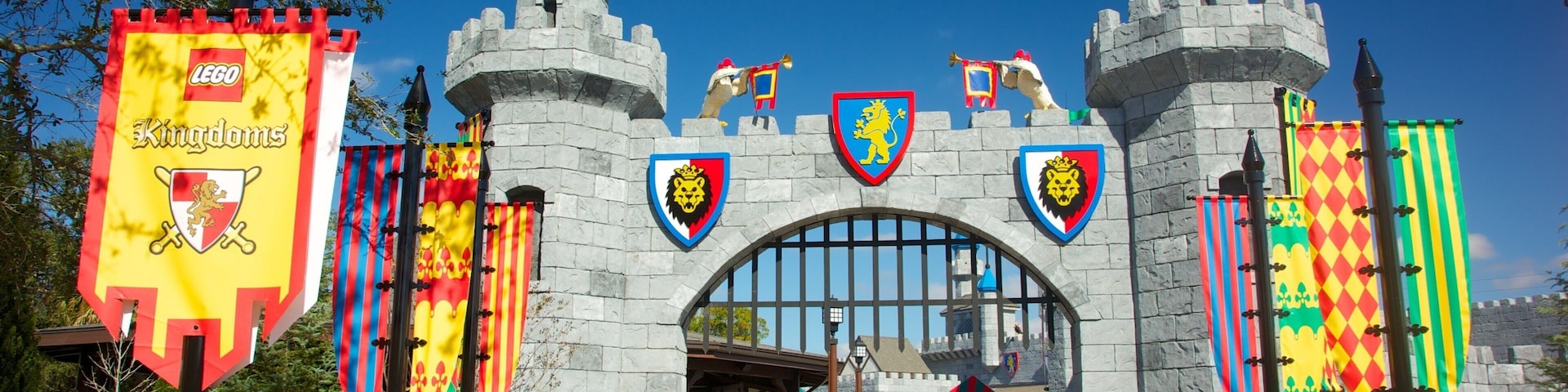 A castle entrance with flags and banners, including a LEGO Kingdoms banner.