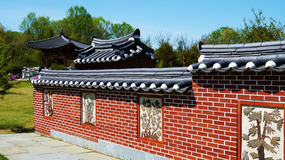 A traditional Korean-style building with tiled roofs and brick walls.
