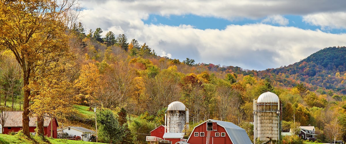 Farm with red barn and silos at sunny autumn day in West Arlington, Vermont, USA