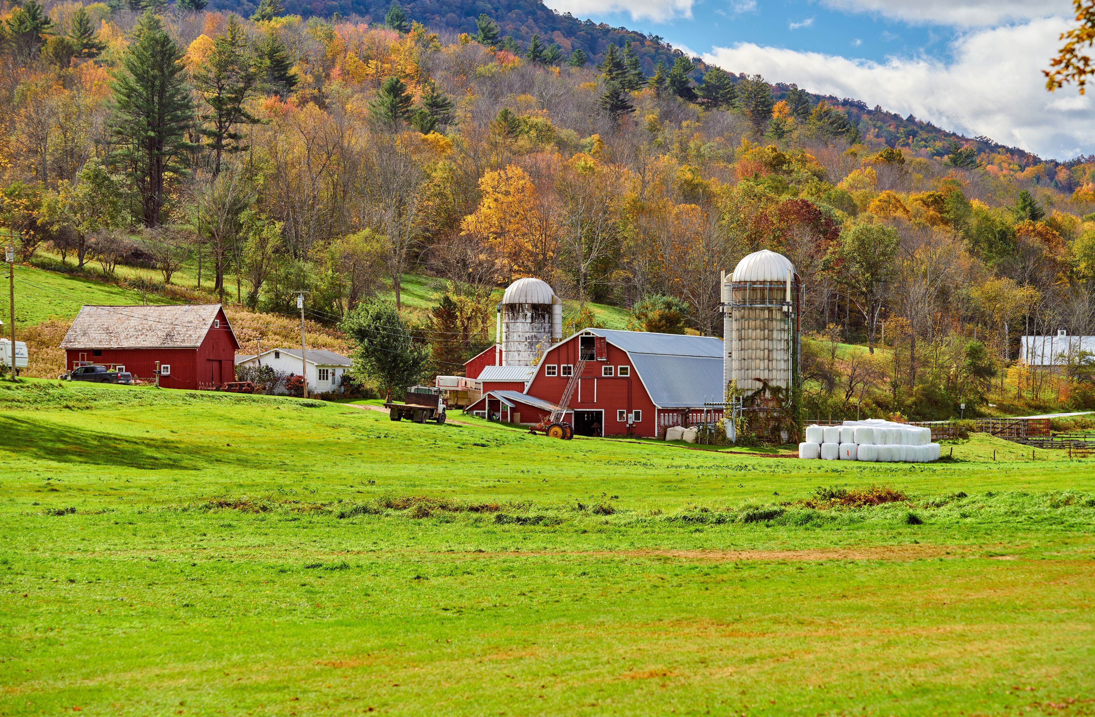 Farm with red barn and silos at sunny autumn day in West Arlington, Vermont, USA