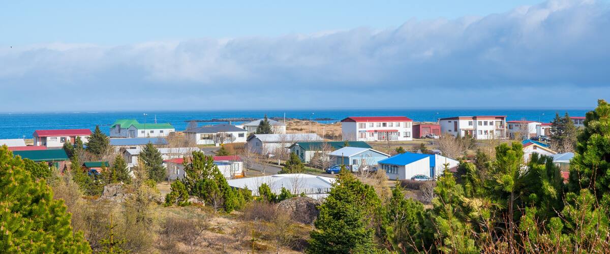 A coastal town with houses and a view of the ocean.