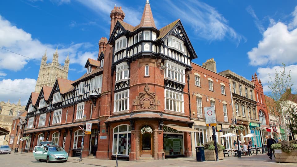 A historic building with Tudor-style architecture, a prominent clock tower, and a pedestrian zone sign.