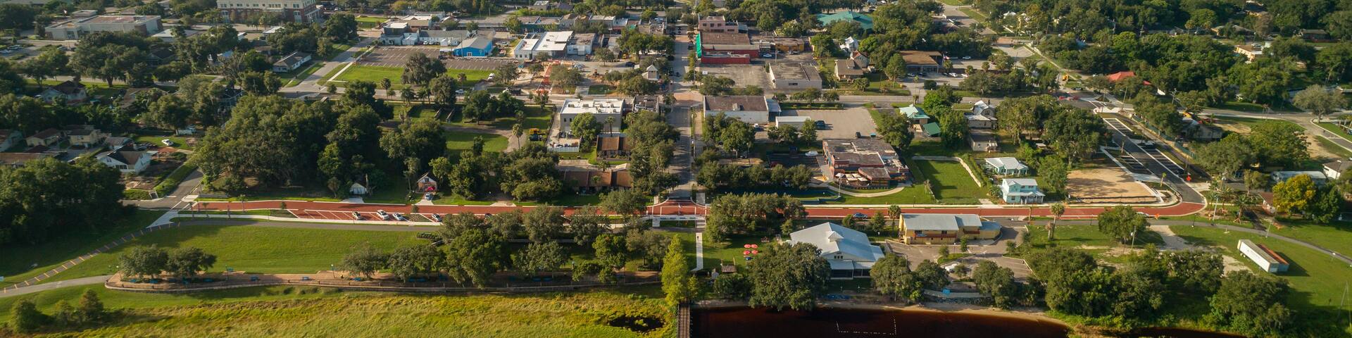 High altitude aerial view over the Lake Minneola lakefront pier in downtown Clermont, Florida.