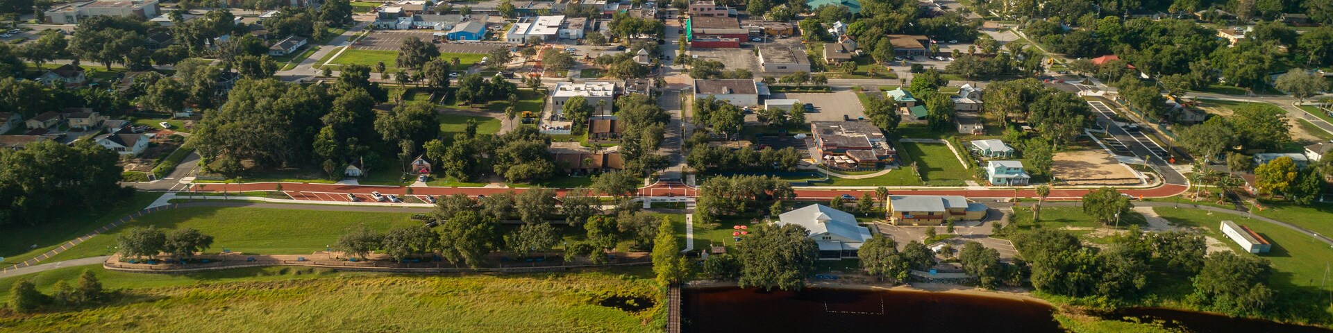 High altitude aerial view over the Lake Minneola lakefront pier in downtown Clermont, Florida.