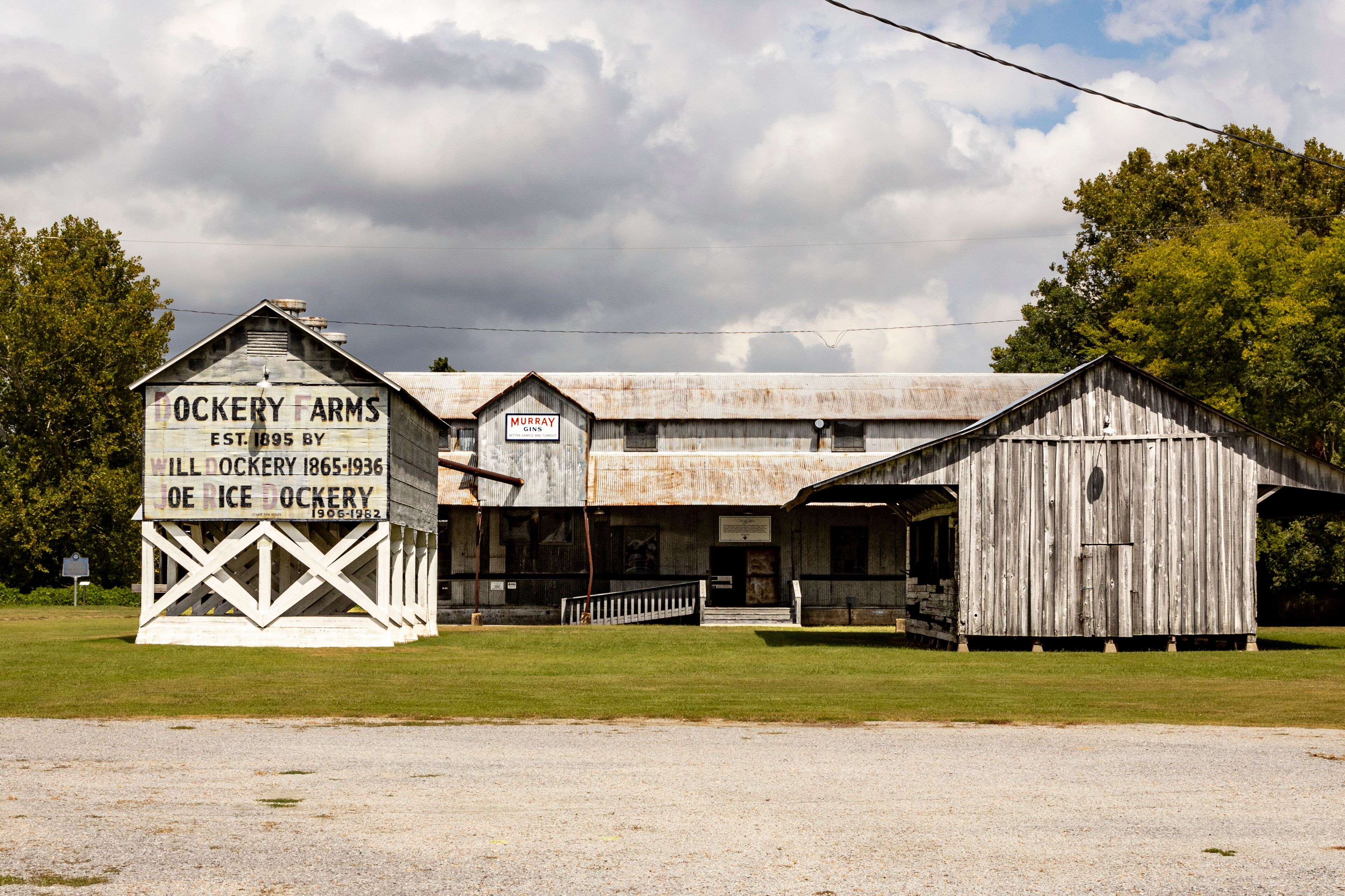 A historic farmstead with a large barn and a sign indicating it was established in 1895.