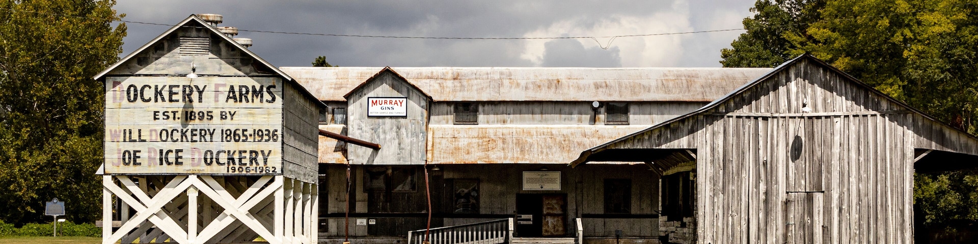 A historic farmstead with a large barn and a sign indicating it was established in 1895.