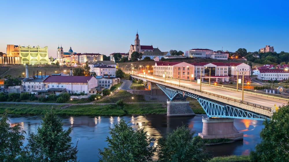 Cityscape of Grodno at dusk with bridge over Neman river, Belarus