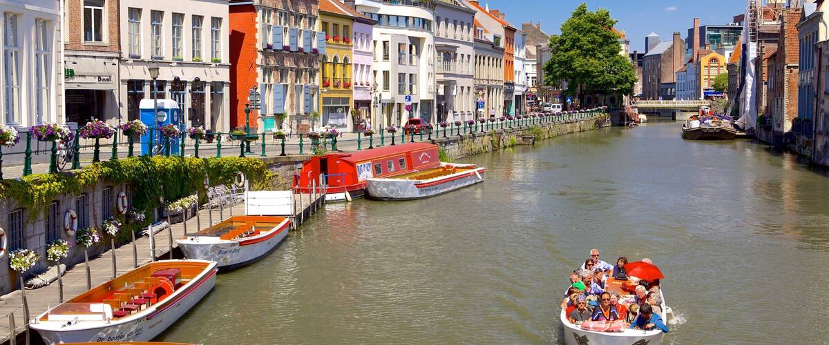 A canal with boats, historic buildings, and a bridge.