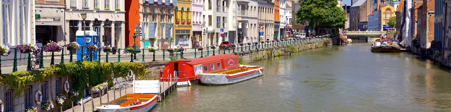 A canal with boats, historic buildings, and a bridge.