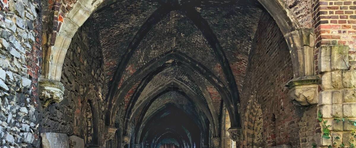 This was my favourite place to visit in Ghent. I could have taken pictures all day in the ruin of St. Bavo's Abbey. An quiet oasis in the city, we were the only people there. So quiet and serene and many courtyards to explore including a medieval church. 
Founded in the 7th century, the former abbey is now ruins echoing the history that took place here. The oldest wall in Ghent stands here.
The original Romanesque church that was destroyed is marked out by lovely hedges so you can see where it once stood as the five-metre-high shrubbery columns mark out the foundations.
Entry was free.