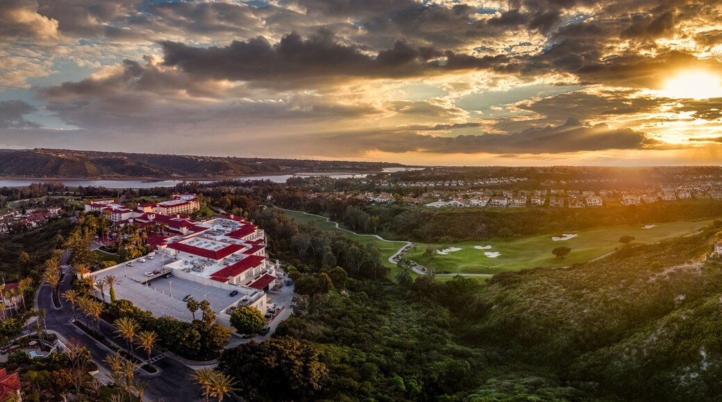 Aerial view of real estate development, luxury villas, single family homes in California near the Pacific Ocean over a gulf course