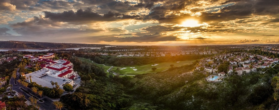 Aerial view of real estate development, luxury villas, single family homes in California near the Pacific Ocean over a gulf course