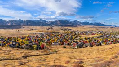 Autumn Foothill Village - A colorful panoramic Autumn day view of a small foothill neighborhood, as seen from North Table Loop Trail. Denver-Golden-Arvada, Colorado, USA.