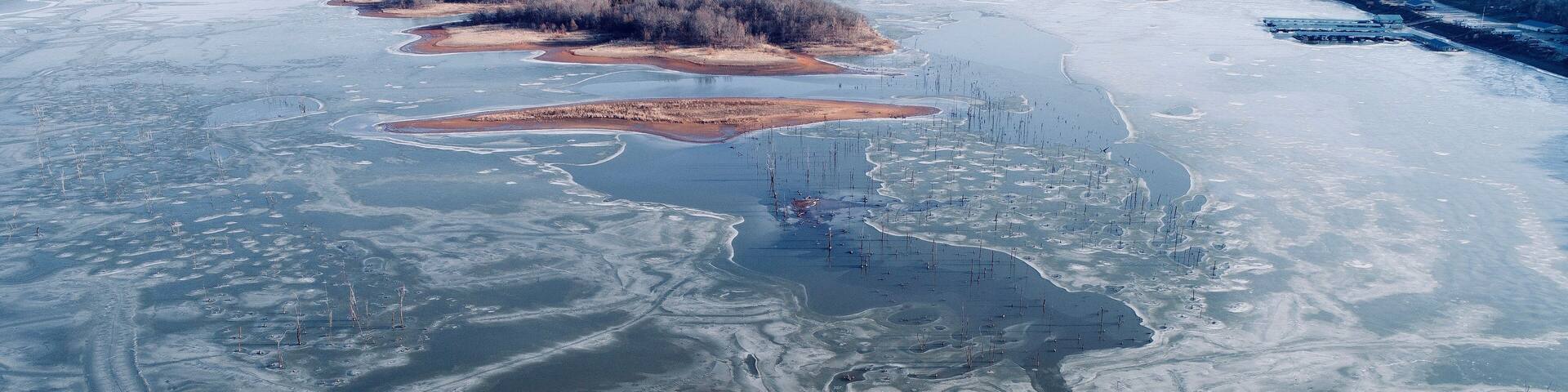 Truman Lake just east of Clinton, Missouri. After a week of freezing weather, this man made lake was just beginning to thaw around the thousands of tree trunks that threaten the hulls of fishing boats