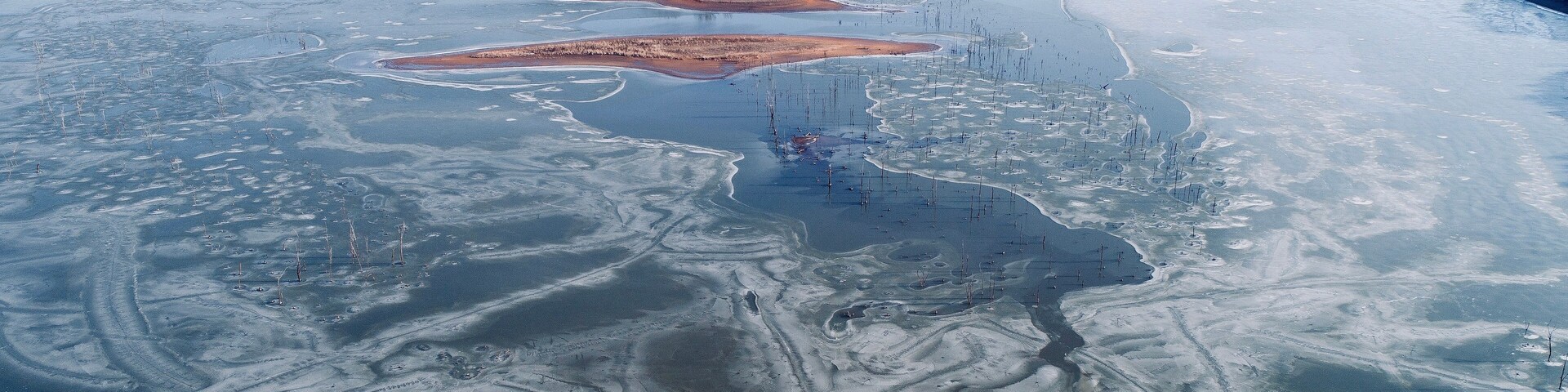Truman Lake just east of Clinton, Missouri. After a week of freezing weather, this man made lake was just beginning to thaw around the thousands of tree trunks that threaten the hulls of fishing boats