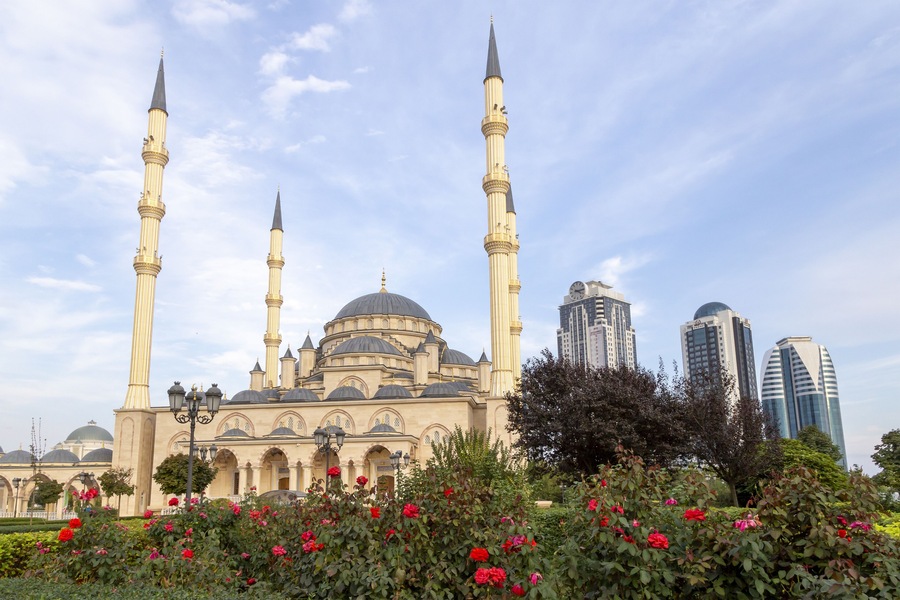 Grozny, Russia: 10.07.2015. Daily life in Chechen Republic. Main mosque of the Chechen Republic - Akhmad Kadyrov Mosque (Heart of Chechnya) and and skyscrapers of Grozny-city