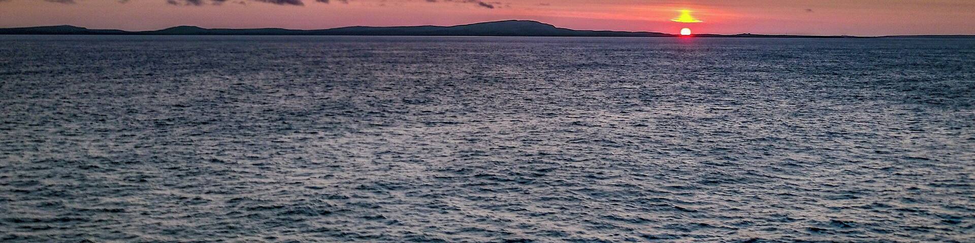 Sunset veiwed from a cruis e ship crossing the Arctic circle.