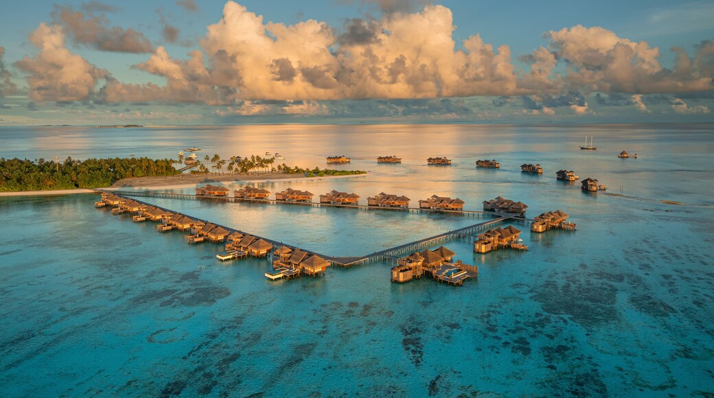 Aerial view of the beautiful tropical island resort with luxurious bungalows and turquoise ocean, Amingiri, Male Atoll, Maldives.