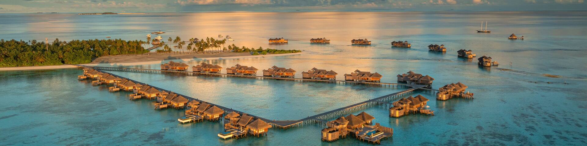 Aerial view of the beautiful tropical island resort with luxurious bungalows and turquoise ocean, Amingiri, Male Atoll, Maldives.